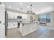 Bright, open kitchen featuring white cabinetry, granite countertops, and stainless steel appliances at 41309 N Belfair Way, Anthem, AZ 85086
