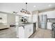 Open-concept kitchen featuring a large island with granite countertops and stainless steel appliances at 41309 N Belfair Way, Anthem, AZ 85086