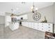 Spacious kitchen featuring white cabinetry, granite countertops, stainless steel appliances, and pendant lighting at 41309 N Belfair Way, Anthem, AZ 85086