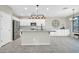Modern kitchen with a central island, stainless steel appliances, white cabinets, and granite countertops at 41309 N Belfair Way, Anthem, AZ 85086