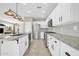 Well-lit kitchen boasting white cabinetry, granite countertops, and stainless steel appliances at 41309 N Belfair Way, Anthem, AZ 85086