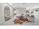Inviting living room with neutral walls, tiled floors, modern furniture, and seamless flow to other spaces at 41309 N Belfair Way, Anthem, AZ 85086