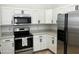 Updated kitchen featuring stainless steel appliances, white cabinets, and sleek hardware at 4799 E Meadow Lark Way, San Tan Valley, AZ 85140