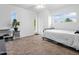 Bright bedroom featuring two windows, carpeted floors, and neutral walls at 4901 W Beverly Ln, Glendale, AZ 85306