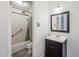 Bathroom featuring a shower and vanity with dark brown cabinet at 4950 N Miller Rd # 135, Scottsdale, AZ 85251