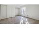 Bedroom with a large window and neutral carpet at 4950 N Miller Rd # 135, Scottsdale, AZ 85251