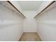 Empty walk-in closet with shelving and carpeted floor at 4950 N Miller Rd # 135, Scottsdale, AZ 85251