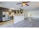 Open kitchen featuring dark cabinets, stainless steel appliances, and an eat-in breakfast bar at 4950 N Miller Rd # 135, Scottsdale, AZ 85251
