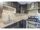 Close up shot of kitchen with stainless steel oven and decorative tile backsplash at 4950 N Miller Rd # 135, Scottsdale, AZ 85251