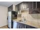 Updated kitchen boasts stainless steel appliances and dark wood cabinetry at 4950 N Miller Rd # 135, Scottsdale, AZ 85251