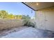 Spacious patio area with stone pavers, textured wall, and an overhanging roof structure at 4950 N Miller Rd # 135, Scottsdale, AZ 85251