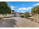 Backyard with mature shade trees, a stone ground cover, and a peek at the back of the house at 5738 E Cicero Rd, Mesa, AZ 85205