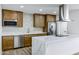 Modern kitchen featuring stainless steel appliances, marble countertops, and custom cabinetry with a kitchen island at 5738 E Cicero Rd, Mesa, AZ 85205