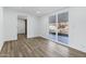 Bright living room with hardwood floors, a sliding glass door leading to the backyard, and fresh white paint at 5738 E Cicero Rd, Mesa, AZ 85205