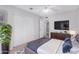 Bedroom with a ceiling fan, dark wood dresser with a TV, and neutral decor at 6270 N 78Th St # 323, Scottsdale, AZ 85250