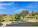 Peaceful golf course view featuring green grass, mature trees, and a clear blue sky at 6270 N 78Th St # 323, Scottsdale, AZ 85250