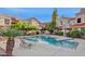 Community pool surrounded by lounge chairs and lush landscaping at 6270 N 78Th St # 323, Scottsdale, AZ 85250
