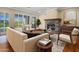 Beautiful living room with stone fireplace, light walls, and natural light from big windows at 6302 N 4Th Dr, Phoenix, AZ 85013