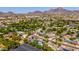 Aerial view of community featuring homes with solar panels, pools, and mountain views at 7028 N 12Th Way, Phoenix, AZ 85020