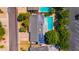 Aerial view of home with solar panels and pool, surrounded by lush greenery at 7028 N 12Th Way, Phoenix, AZ 85020