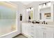 Bright bathroom features a dual sink vanity with marble countertop and modern black fixtures at 7028 N 12Th Way, Phoenix, AZ 85020