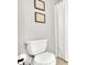 Bathroom featuring a toilet and white waffle shower curtain with decorative wall art at 7028 N 12Th Way, Phoenix, AZ 85020