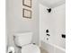 Bright bathroom featuring a toilet and tiled shower with a modern matte black shower head at 7028 N 12Th Way, Phoenix, AZ 85020