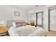 Bedroom featuring a neutral bed frame, minimalist decor, and a mirrored closet at 7028 N 12Th Way, Phoenix, AZ 85020