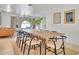 Bright dining room featuring an arched window and seating for eight at 7028 N 12Th Way, Phoenix, AZ 85020
