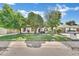 Charming single-story home with mature trees, a well-manicured lawn, and a welcoming facade at 7028 N 12Th Way, Phoenix, AZ 85020