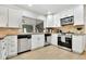 Well-appointed kitchen with white cabinetry, stainless steel appliances, and stylish countertops at 7028 N 12Th Way, Phoenix, AZ 85020
