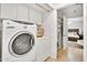 Laundry room featuring a washer and dryer, overhead storage, and an open doorway to the Primary at 7028 N 12Th Way, Phoenix, AZ 85020