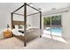 Main bedroom featuring a four-poster bed and pool view at 7028 N 12Th Way, Phoenix, AZ 85020