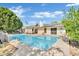 Sparkling pool with solar panels on home in backyard with covered patio, perfect for relaxation and outdoor fun at 7028 N 12Th Way, Phoenix, AZ 85020