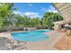 Spacious backyard featuring a pristine pool, covered patio, and privacy fence for ultimate enjoyment at 7028 N 12Th Way, Phoenix, AZ 85020
