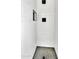 Shower with white tile, black hardware, and a gray tiled floor at 7028 N 12Th Way, Phoenix, AZ 85020