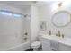 Bright white bathroom with marble countertops, gold hardware, a round mirror, and shower at 72 S Willow Creek St, Chandler, AZ 85225