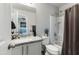 Bathroom featuring a shower, toilet, white vanity, framed mirror, and granite countertops at 7807 W Palm Ln, Phoenix, AZ 85035
