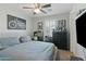 Bedroom features a ceiling fan, shuttered windows, and a black dresser with decor at 7807 W Palm Ln, Phoenix, AZ 85035