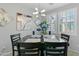 Elegant dining room featuring modern light fixture, stylish decor, and window at 7807 W Palm Ln, Phoenix, AZ 85035