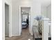 Hallway view looking into a bedroom with gray walls, neutral carpet, and decorated with stylish decor at 7807 W Palm Ln, Phoenix, AZ 85035