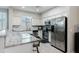 Well-lit kitchen featuring white cabinets, stainless steel appliances, and a granite countertop island at 7807 W Palm Ln, Phoenix, AZ 85035