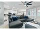 Open-concept living room with a large sectional sofa and ceiling fan at 7807 W Palm Ln, Phoenix, AZ 85035
