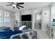 Stylish living room with a ceiling fan, a flat screen tv, and comfortable seating at 7807 W Palm Ln, Phoenix, AZ 85035
