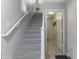 Bright staircase leading to the upper level, adjacent to laundry room at 7807 W Palm Ln, Phoenix, AZ 85035