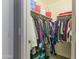 Walk-in closet featuring an assortment of clothing hanging on the clothing racks and neutral carpet at 7807 W Palm Ln, Phoenix, AZ 85035