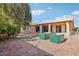 Expansive backyard features a covered patio, desert landscaping, and raised garden planters at 9429 E Nacoma Dr, Sun Lakes, AZ 85248