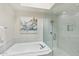 Bathroom features soaking tub and glass enclosed shower with modern fixtures and decor at 9429 E Nacoma Dr, Sun Lakes, AZ 85248