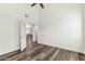 Bright bedroom has modern flooring, neutral paint, and door leading to the living room at 9429 E Nacoma Dr, Sun Lakes, AZ 85248