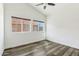 Bright bedroom features modern ceiling fan, neutral paint, and wood-look floors at 9429 E Nacoma Dr, Sun Lakes, AZ 85248